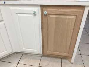That blue piece of painters tape is DH figuring out measurements to see if it's possible to replace the garbage can cabinet with a standard-size cabinet-- it wasn't.